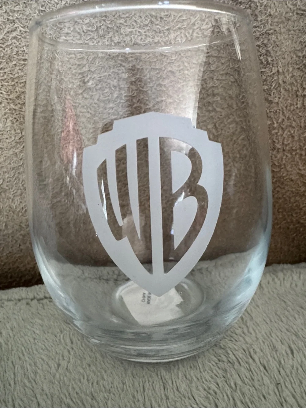 Warner Bros. Clear Stemless Wine Glass with White Etched WB Shield, new